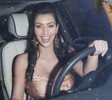 Kim Kardashian in spaghetti strap top without bra showing big cleavage at streets in Los Angeles